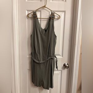 Adorne Woman Nia v-neck pleated olive green romper shorts with pockets.